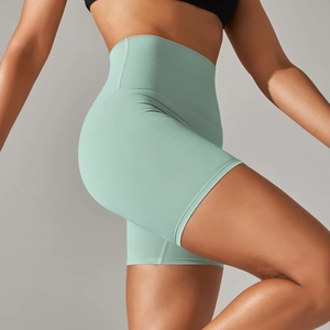 Detail view of mint green high-waisted yoga shorts with seamless fabric texture