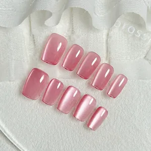 Short square pink cat-eye press-on nails set with magnetic shimmer on lace background