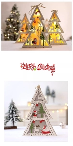 Close-up of wooden Christmas tree decor with LED lights and Santa Claus carving