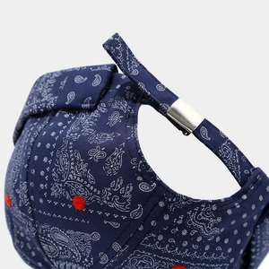 Detail of navy paisley docker hat with red embroidery and silver metal strap buckle
