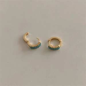 Detail of 925 sterling silver hoop earrings with a row of square turquoise stones