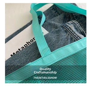 Detailed macro view of the cyan mesh beach bag featuring reinforced cross-stitched handles