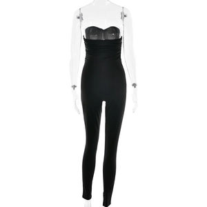 Detail of black strapless jumpsuit featuring ruched waist and slim fit elastic fabric