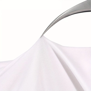 Macro detail of breathable white UV protection fabric texture for manicure gloves