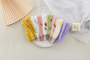 Flat lay of soft mink velvet plush socks with floral patterns in assorted colors