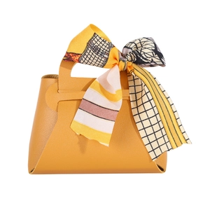 Elegant yellow faux leather wedding favor gift bag with decorative printed silk scarf handle
