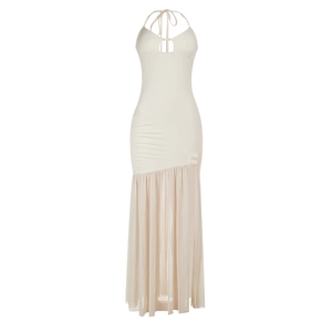 Detail of ivory halter dress featuring mesh patchwork and beaded decorative elements