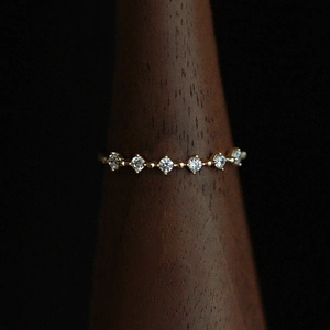 Minimalist 18K gold plated silver ring with micro-pave cubic zirconia on wood stand