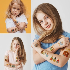Detailed view of kids waterproof nativity scene temporary tattoos on child's arm and face