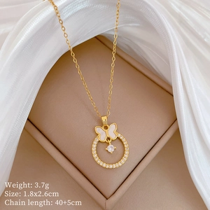 Detail of butterfly and crystal ring pendant on gold chain with dimensions info