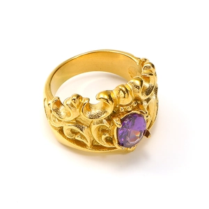 Detail showing vintage gold crown ring with a purple oval gemstone and intricate relief