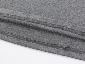Close-up of double-stitched hem and high-quality grey knit fabric texture