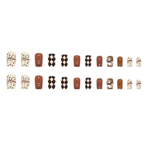 Japanese press-on nails set with checkered patterns and sparkling diamond accents