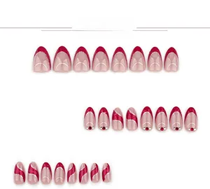 Detail of red French almond press-on nails with silver glitter and rhinestone accents