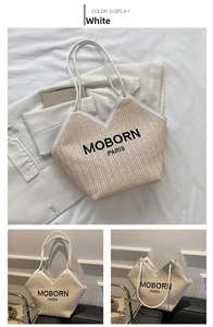 Detail of hand-woven straw bucket bag with white leather trim and MOBORN PARIS logo