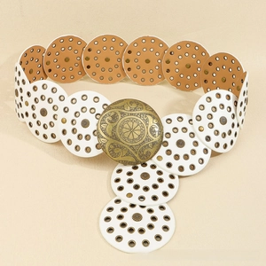 Detail of bohemian decorative belt with vintage floral engraved round metal buckle