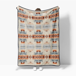 Detail of soft flannel blanket with colorful southwest geometric pattern and bound edges