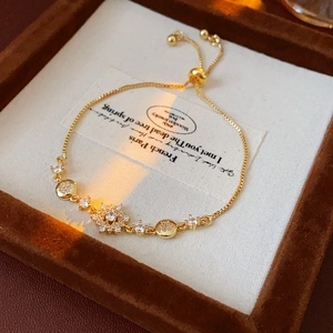 Gros plan d'un bracelet flocon de neige doré avec zircons sur un écrin en velours luxe