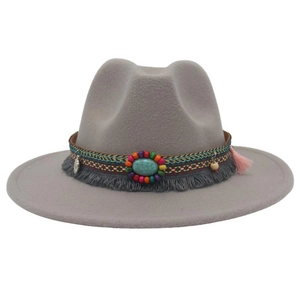 Close-up of bohemian grey felt hat with turquoise beads and tassel decoration