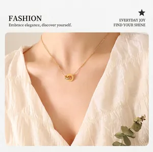 Detail of interlocking Roman numeral gold and pavé crystal double ring necklace