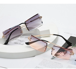 Detail view of stylish rimless square sunglasses with gradient lenses and gold metal temples
