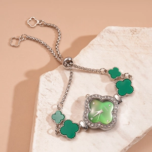 Detail of clover shape watch face with white crystals and adjustable slider chain