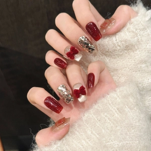 Handmade coffin nails with red velvet bows and shimmering silver glitter accents