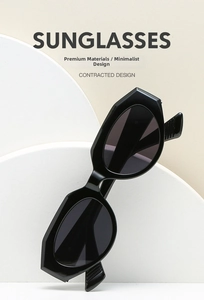 Macro detail of black cat-eye sunglasses with geometric frames and textured temples