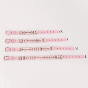 Detailed view of pink faux leather pet collars with elegant pearls and rhinestone buckles