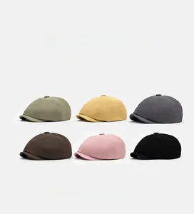 Six colors of octagonal newsboy hats shown in a neat grid display with twill texture