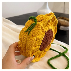 Handcrafted crochet sunflower shoulder bag with yellow petals and green knit strap