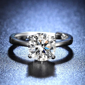 Macro shot of 1 carat round moissanite ring with classic four-prong crown setting