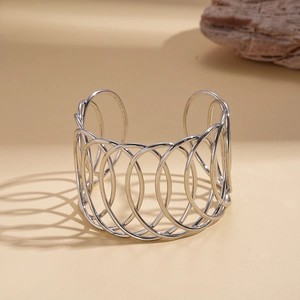 Macro view showing the intricate layered silver hollow mesh design of the open cuff bracelet
