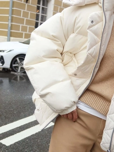 Close-up of white padded puffer jacket showing high-quality texture and side profile view