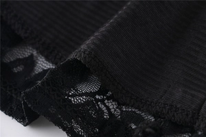 Close-up of black lace trim and ribbed fabric texture on the elegant short dress