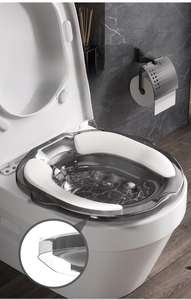 Close-up of a smoke grey sitz bath basin with white anti-slip pads on a toilet seat