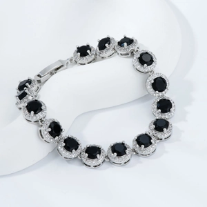 Detail showing halo-set round black stones and pavé cubic zirconia on a silver bracelet