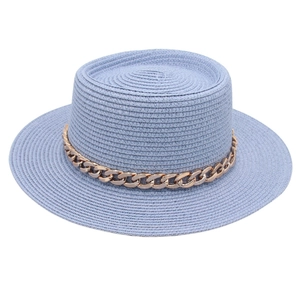 Macro detail of a blue boater straw hat with stylish decorative gold acrylic chain