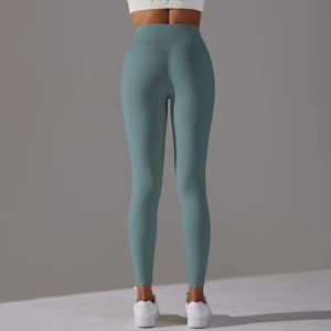 Détail de la taille haute sans couture et de l'effet liftant du legging de yoga bleu gris