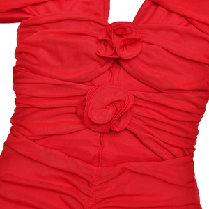 Detail of red mesh dress showing sweetheart neckline and 3D fabric rose floral accents