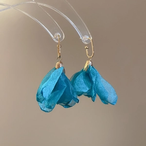 Detail of peacock blue chiffon flower earrings with elegant gold-plated metal hooks