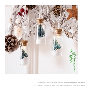 Detail of LED glass wishing bottle lights with miniature Christmas trees and snow inside