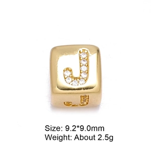 Macro detail of 8mm gold letter J charm with micro-pave cubic zirconia and dimensions