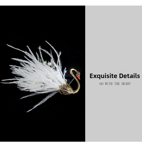 Detailed view of swan brooch with white feathers, golden metal, and pearl accents