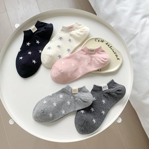 Close-up of five pairs of cotton ankle socks with star patterns in various soft colors