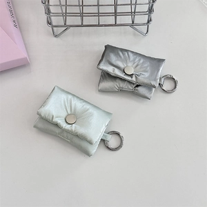 Detail of silver and mint green puffy headphone cases with metal hooks and snap buttons