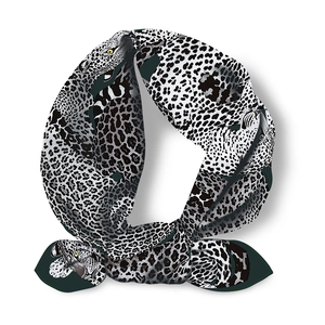 Detailed close-up of a twilly scarf with realistic black and white leopard print patterns