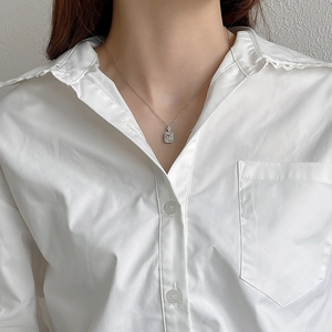 Detailed close-up of S925 silver necklace featuring a rectangular zircon pendant on model