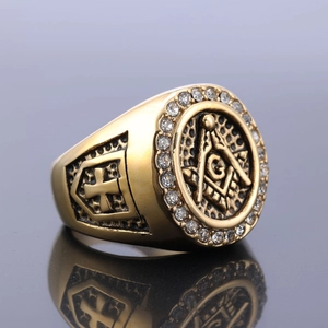 Detailed macro view of gold-plated Freemasonry ring with zircon inlay and side cross carving