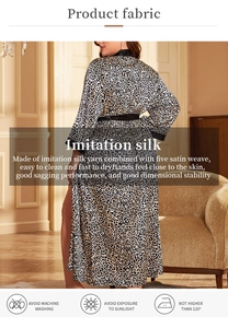 Detailed view of leopard print faux silk robe with smooth texture and black satin trim